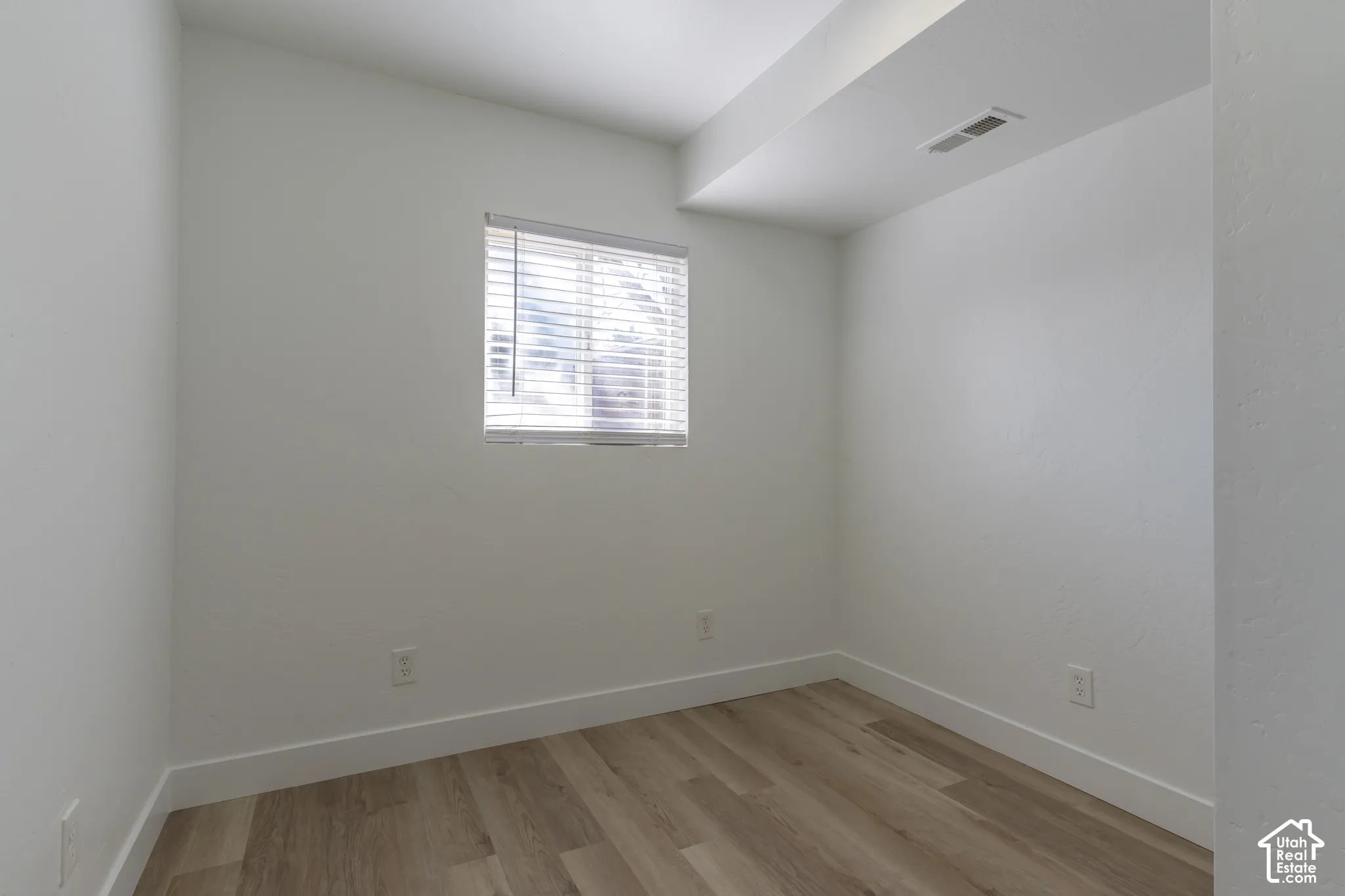 ADU bedroom with new LVP and lighting