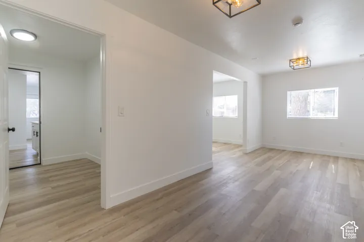 Oversized entry with new LVP and lighting. View looking into office/living room and laundry room
