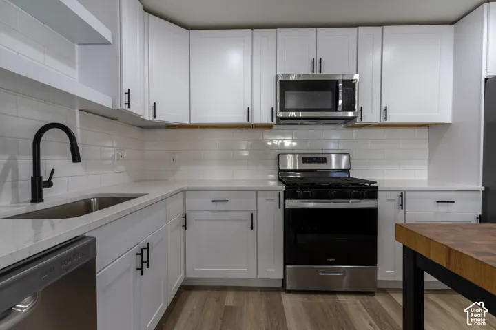 Brand new kitchen with new cabinetry, quartz countertops, backsplash, and stainless-steel appliances