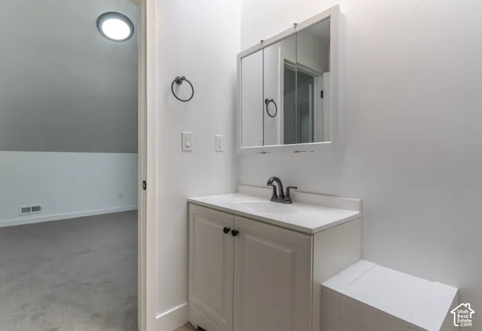 Second floor bathroom with new LVP, cabinetry, and fixtures.