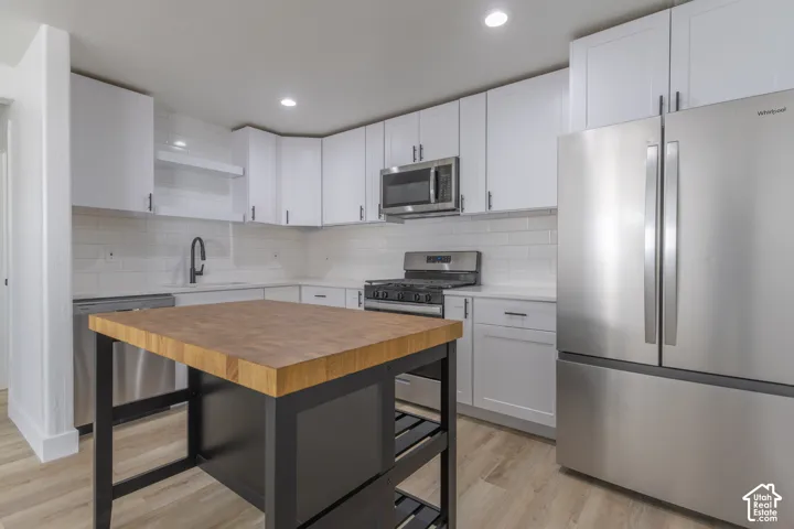 Brand new kitchen with new cabinetry, quartz countertops, backsplash, and stainless-steel appliances