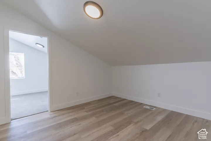 Private sitting area attached to primary bedroom with vaulted ceilings, bult in skylight, and new LVP.