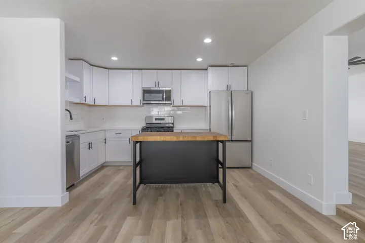 Brand new kitchen with new cabinetry, quartz countertops, backsplash, and stainless-steel appliances