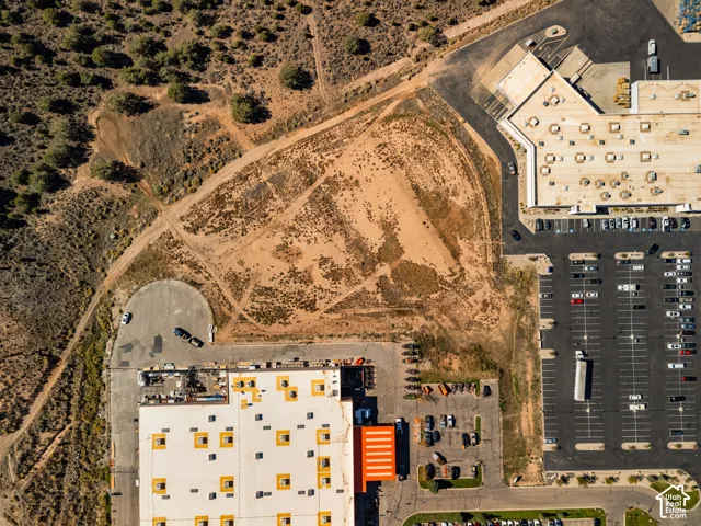 Expansive parcel of undeveloped land with direct access to paved thoroughfares and proximity to existing commercial infrastructure