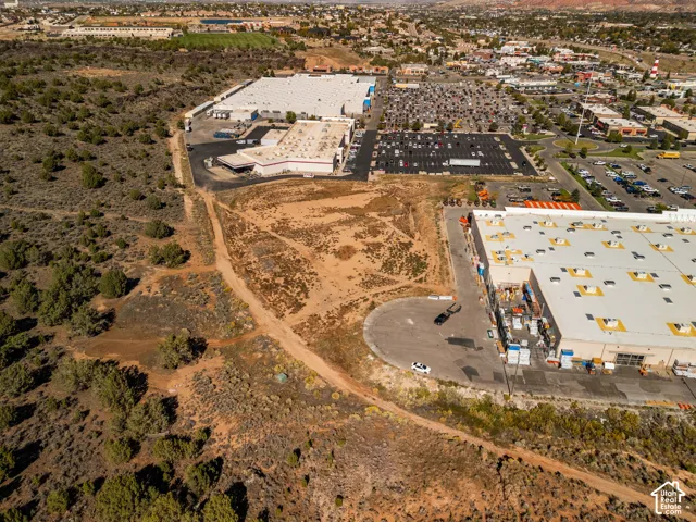 Undeveloped parcel featuring native high-desert vegetation, unpaved terrain, and proximity to regional commercial infrastructure