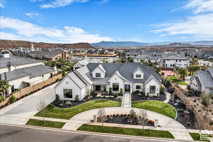 Single-level architectural exterior featuring a light-toned stucco fa