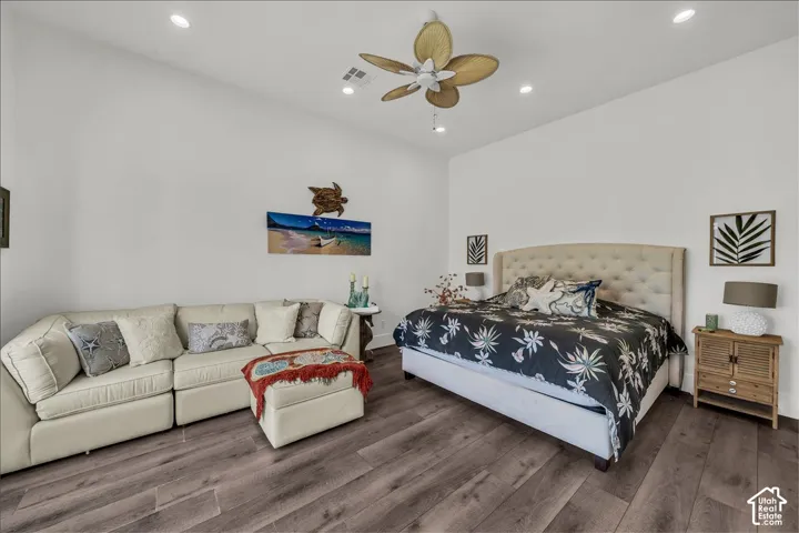 High-ceiling room featuring wood-finish flooring, recessed lighting, and a five-blade ceiling fan