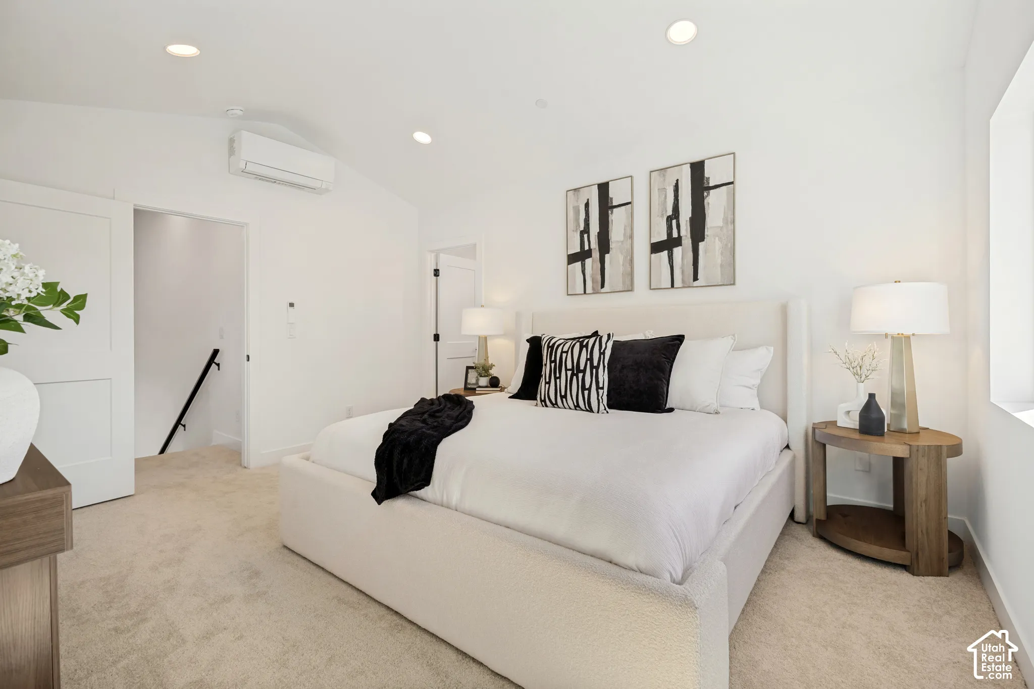 Vaulted ceilings featuring recessed lighting and a wall-mounted ductless heating and cooling unit