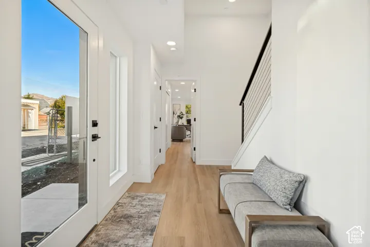 Entryway featuring wood-finish flooring, recessed lighting, and a staircase with a horizontal cable railing and dark handrail