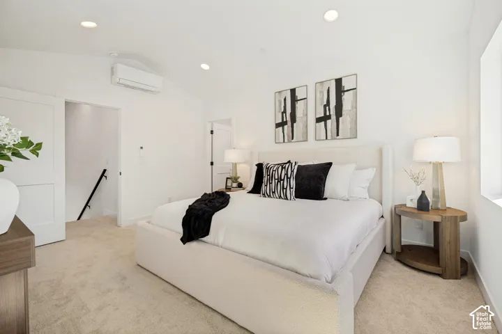 Vaulted ceilings featuring recessed lighting and a wall-mounted ductless heating and cooling unit