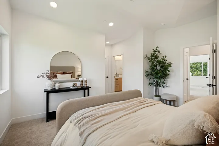 Neutral-toned interior featuring high ceilings, recessed lighting, and wall-to-wall carpeting