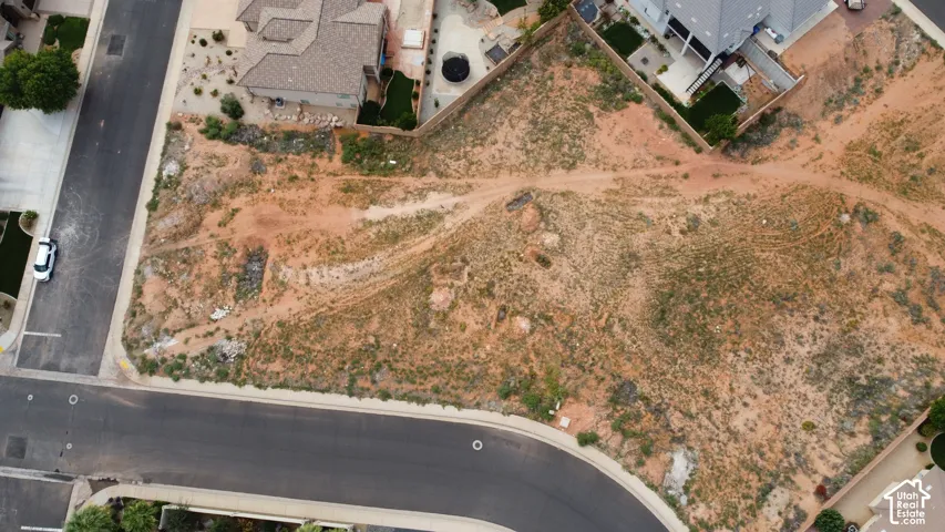 Vacant corner lot featuring paved street access, utility connection points, and established residential infrastructure