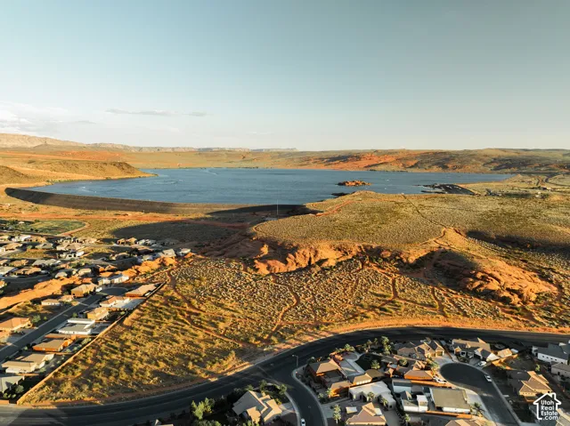 Aerial perspective featuring expansive desert terrain, proximity to a large reservoir, and high-desert mountain backdrops