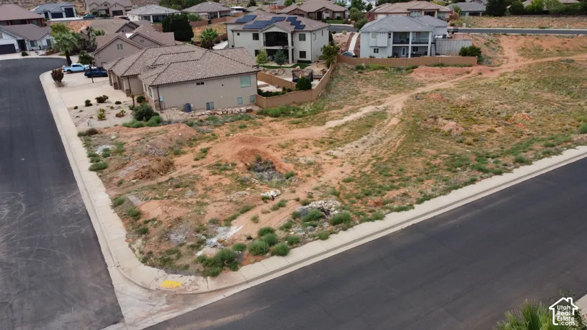 Corner lot featuring paved street access, curbs, and utility connections