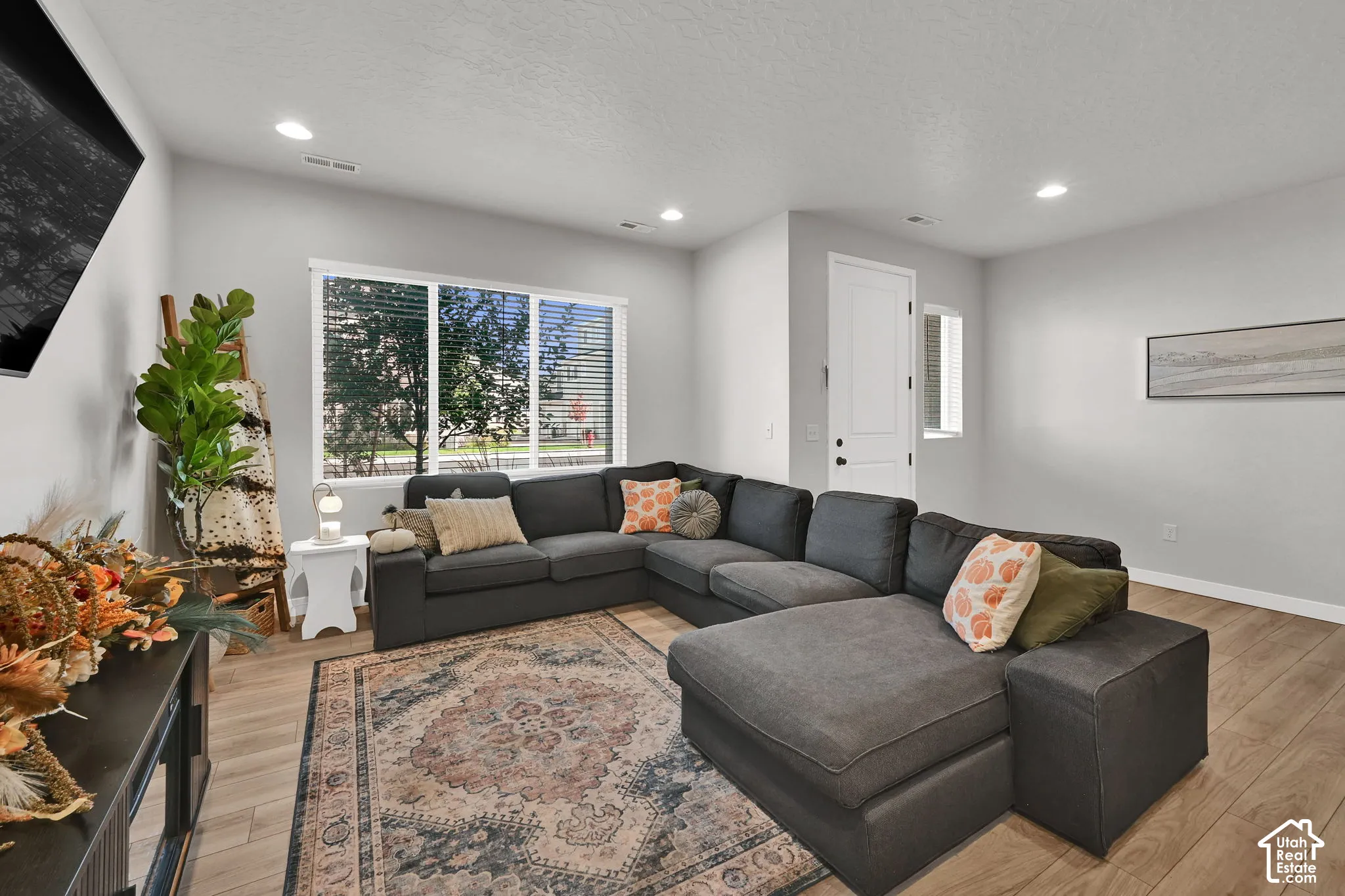 Neutral interior featuring wood-finish flooring, recessed lighting, and a multi-pane window