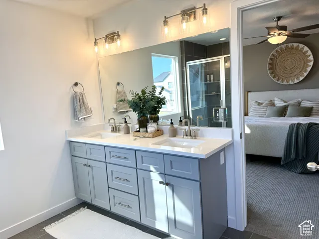 Double vanity with light gray cabinetry and white countertops