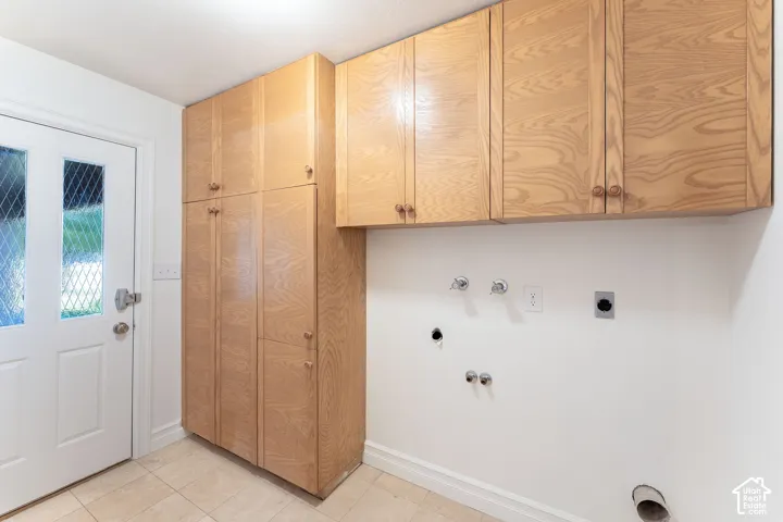 Built-in wood-finish cabinetry, ceramic tile flooring, and a glass-paneled exterior door