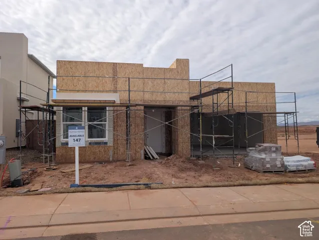 Single-story residential structure featuring oriented strand board exterior sheathing, dual-pane windows, and a covered entryway