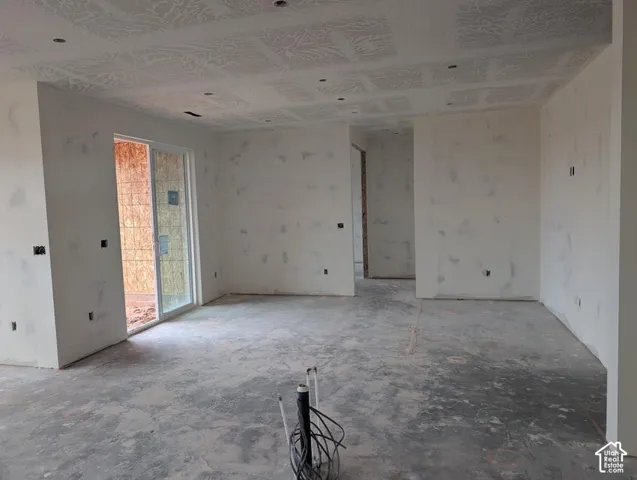 Interior space featuring recessed lighting, a patterned ceiling finish, and a sliding glass door