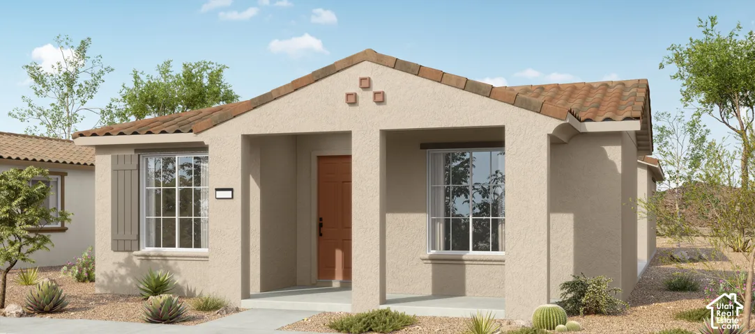 Stucco exterior featuring a covered front porch, clay tile roof, and decorative gable accents