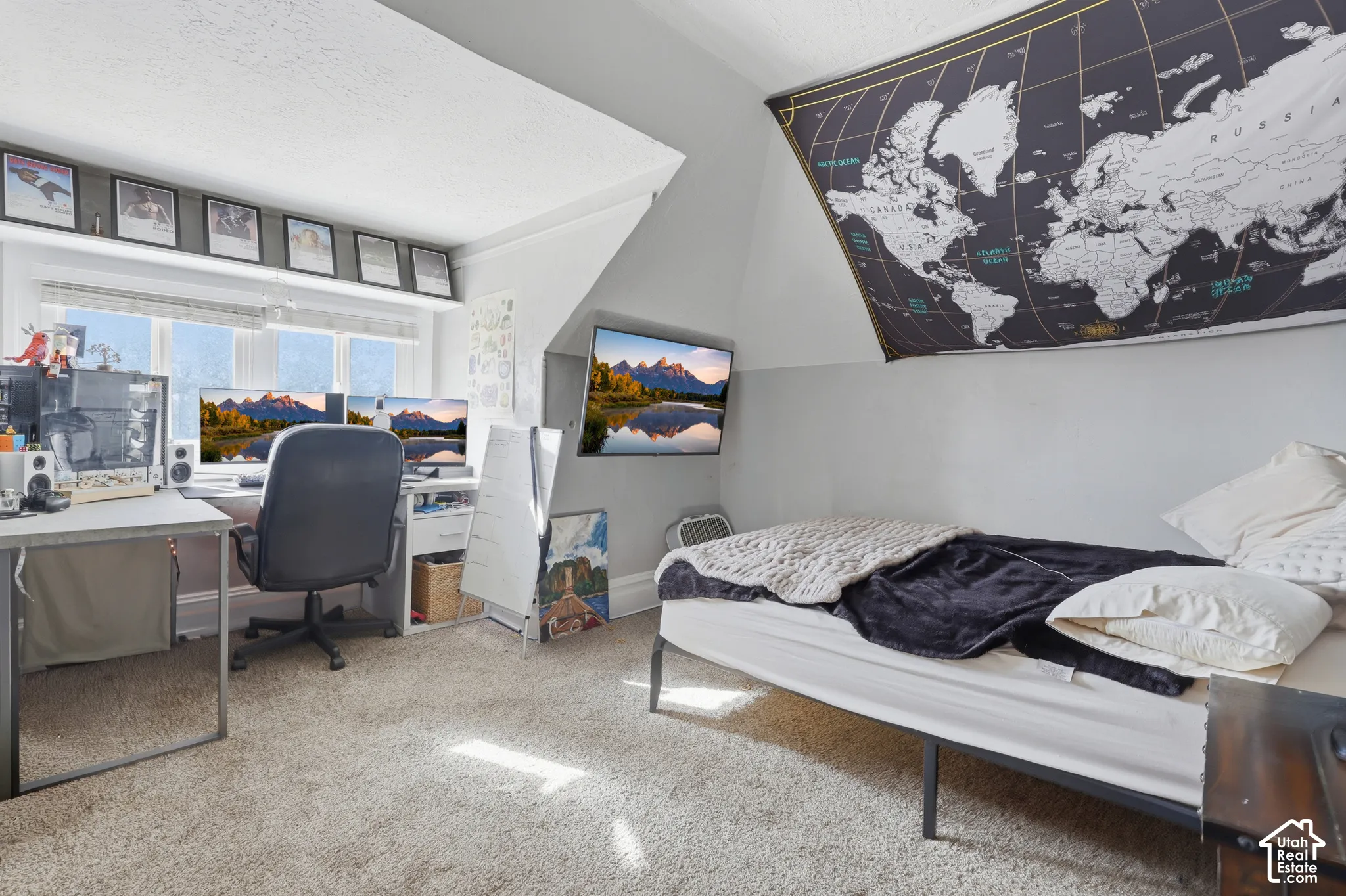 Neutral carpeted flooring, built-in shelving, angled ceiling architecture, and window installation