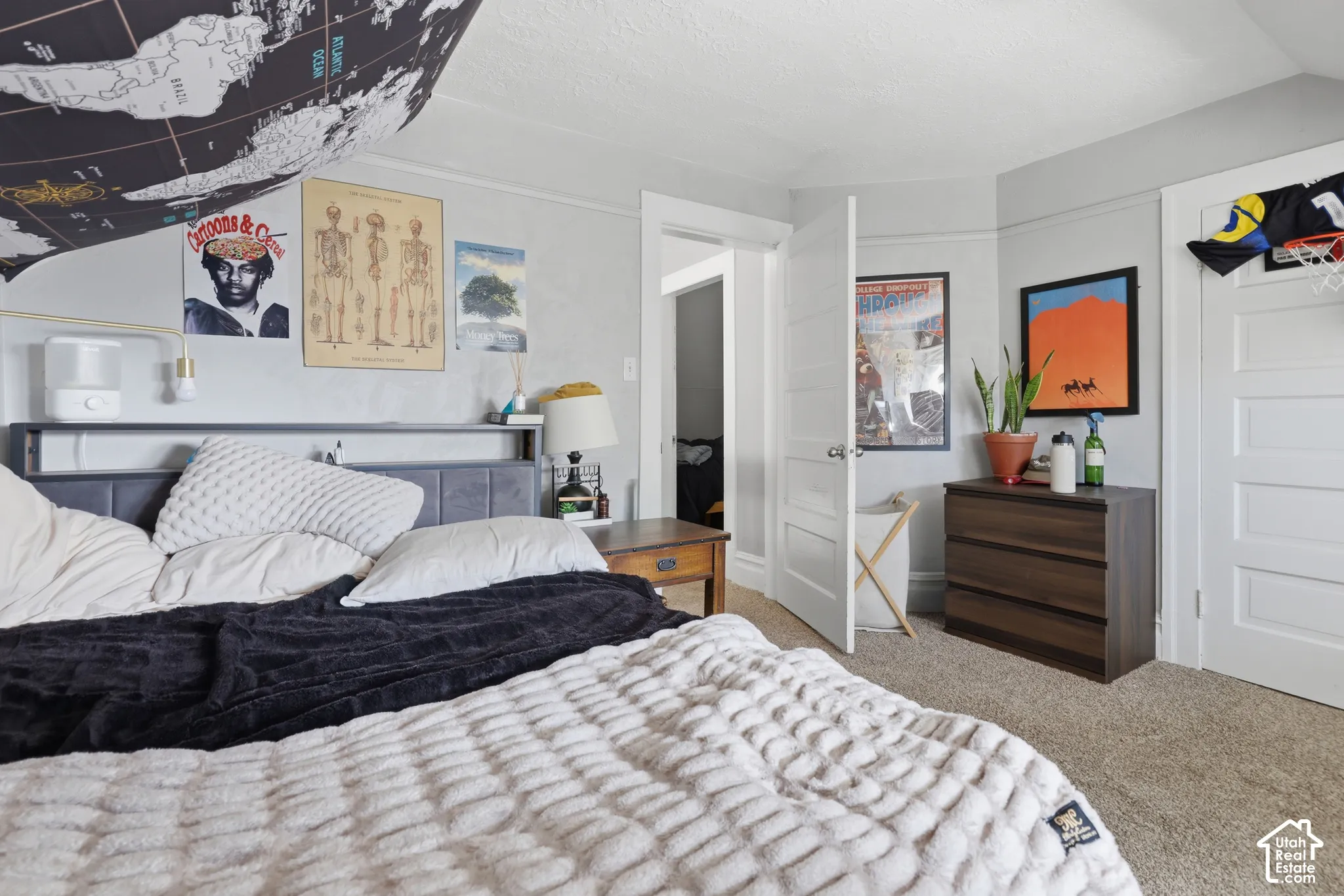 Interior room featuring neutral wall paint, carpeted flooring, and multi-panel solid-core interior doors with traditional trim