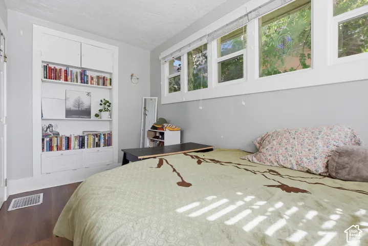 Built-in white wall shelving with lower cabinetry and multiple window panels featuring white trim