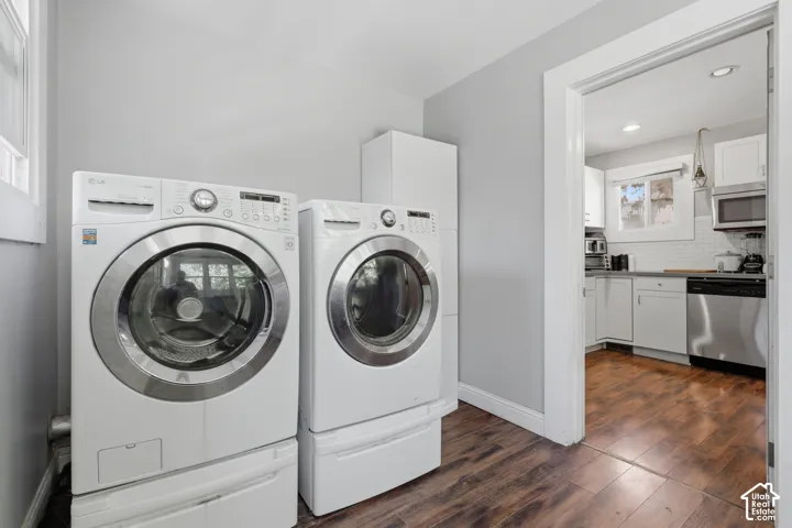 Laundry area featuring wood-finish flooring, a built-in vertical storage cabinet, and recessed ceiling lighting
