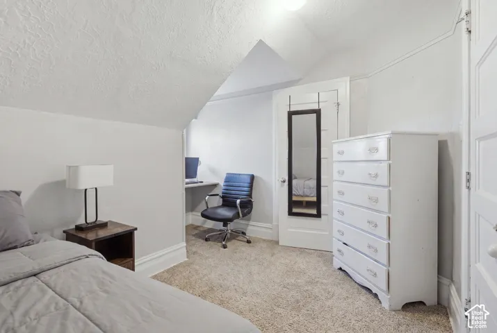 Sloped ceiling, built-in desk, and five-panel interior doors