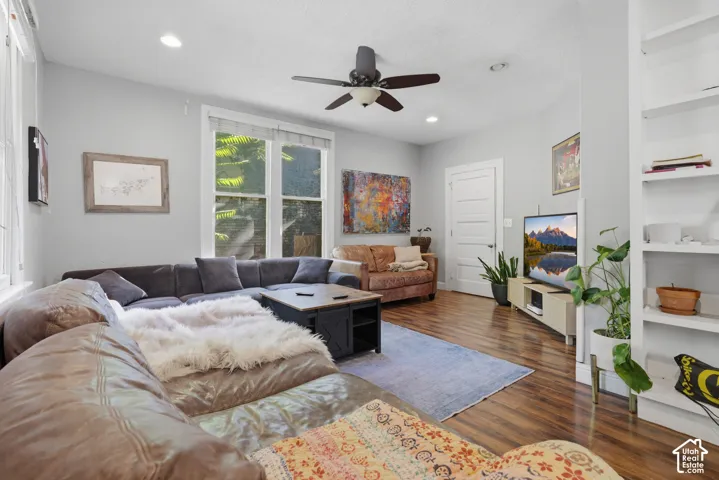 Wood-finish flooring, recessed lighting, ceiling fan, and built-in shelving
