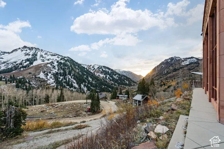 Expansive exterior terrace featuring natural stone masonry and mountain terrain