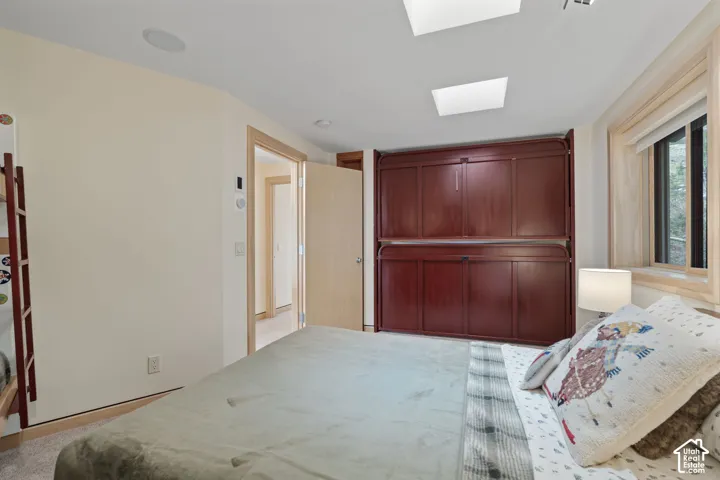 Built-in mahogany-finish cabinetry, dual skylights, recessed lighting, and natural wood window trim