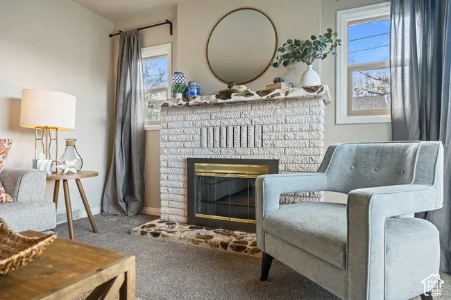 White-painted brick fireplace with a brass firebox