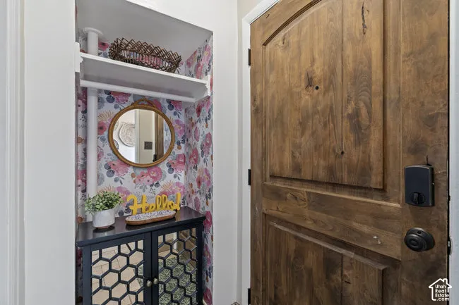 Wood-finish door with paneled detailing and a smart lock system