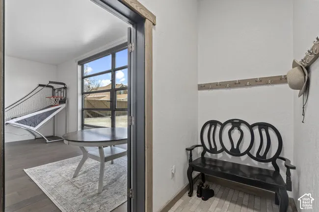 Entryway with durable tile flooring and wall-mounted coat racks