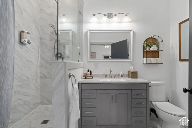 Walk-in shower with full-height tile surround, glass enclosure, and a built-in bench