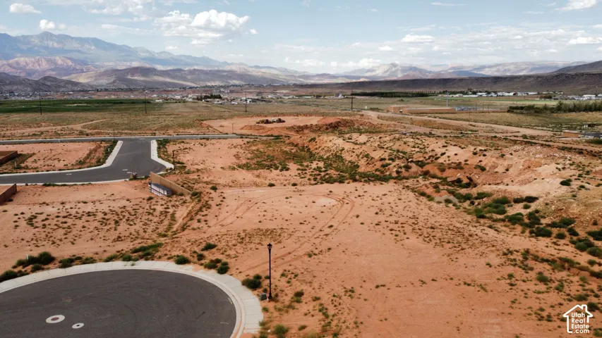 Undeveloped land featuring paved cul-de-sac access, street lighting, and mountain scenery