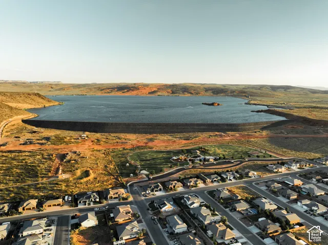 Aerial perspective of residential area featuring proximity to a large reservoir, expansive desert landscape, and established street infrastructure