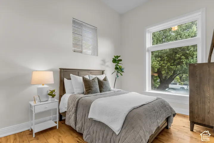 High ceilings, wood-finish flooring, oversized window, and custom casing