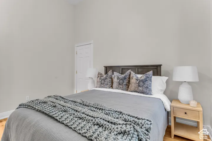 High ceilings, neutral wall palette, and wood-finish flooring