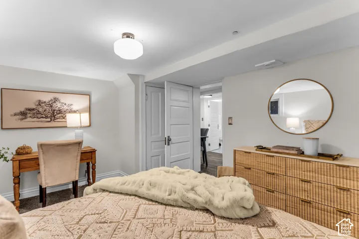 Neutral-toned room featuring a semi-flush mount globe ceiling light, circular wall-mounted mirror, and multi-panel interior door