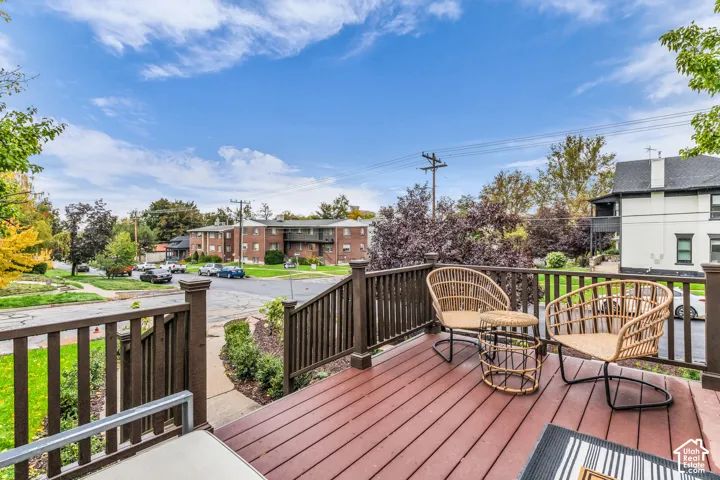 Elevated wooden deck featuring sturdy vertical balustrades and a rich, dark-toned stain
