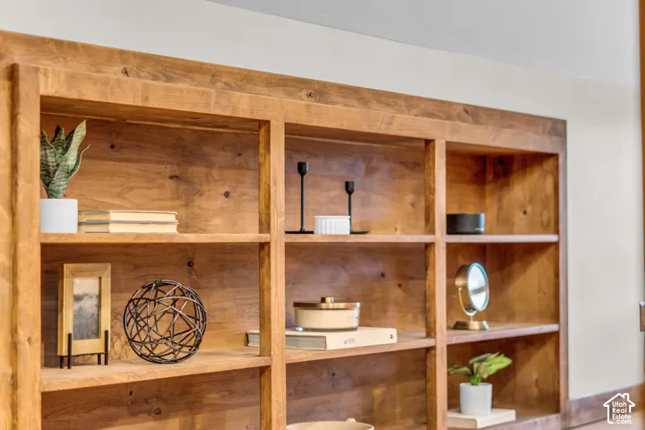 Custom built-in wood shelving featuring tiered horizontal surfaces and stained grain finish