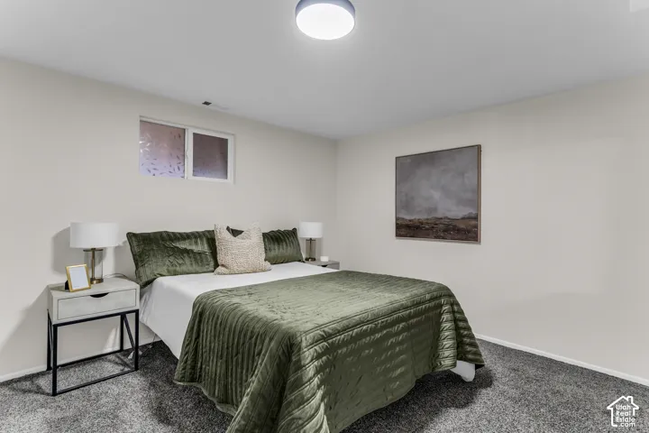 Neutral-toned interior space featuring wall-to-wall carpeting and a recessed sliding window with frosted glass