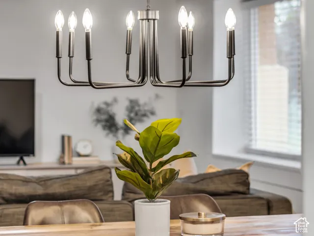 Contemporary eight-light chandelier featuring a matte black finish and candelabra-style bulbs