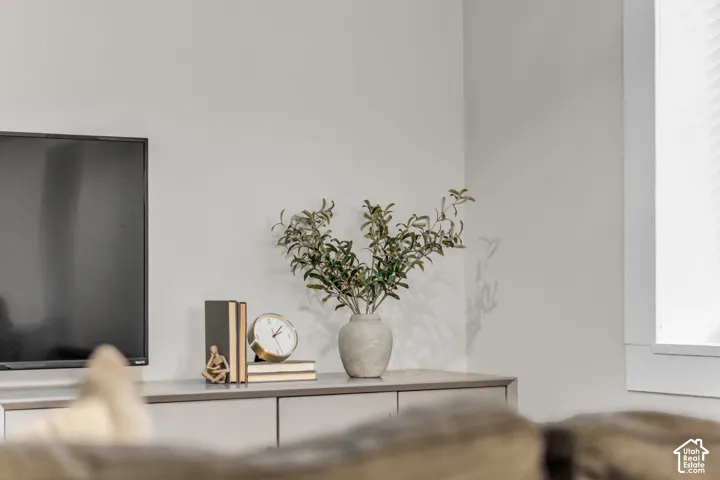 Neutral-toned wall finish with a built-in cabinetry unit and window featuring classic casing