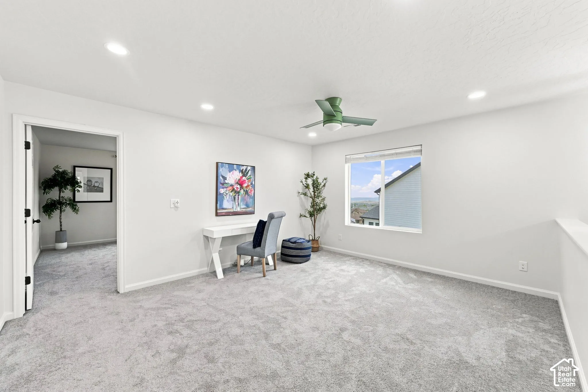 Neutral wall-to-wall carpeting, recessed LED lighting, and a ceiling fan with integrated light fixture