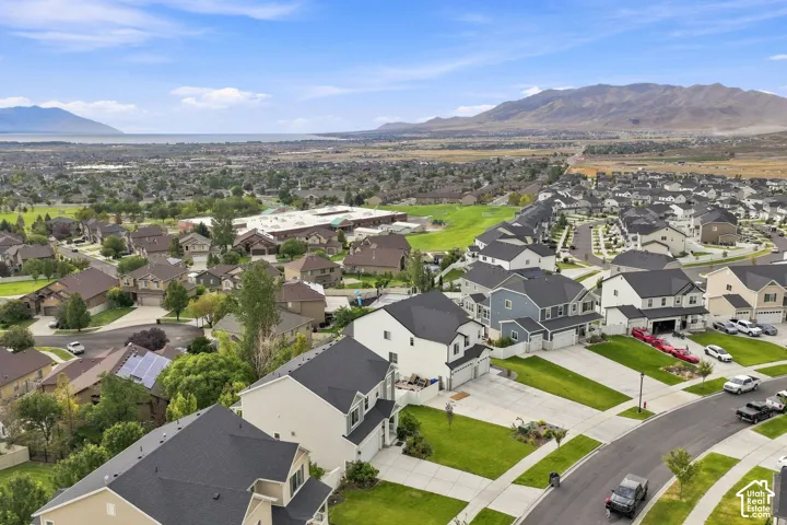 Aerial perspective featuring residential lots, asphalt streets, and mountain range backdrop