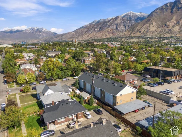 Aerial perspective featuring mountain range backdrop and paved surface parking