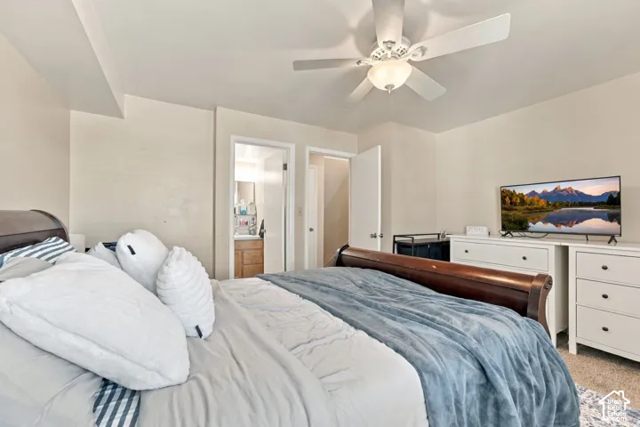 Interior space featuring neutral wall paint, overhead ceiling fan with integrated lighting, and carpeted flooring